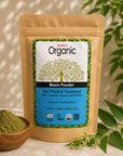 A stand-up pouch of Radico Organic Neem Powder hair wash and treatment, shown with a small wooden bowl of green powder and neem leaves on a beige surface.