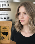 Woman with ash blonde hair next to a 'Colour Me Organic' hair color package.
