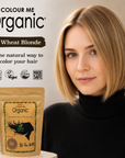 Woman with blonde hair next to a packet of Colour Me Organic hair color, with branding and product details displayed.