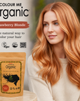 Woman with strawberry blonde hair next to 'Colour Me Organic' hair color packaging.