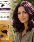 Woman with purple hair next to 'Colour Me Organic' hair color packaging