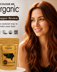 Woman with copper brown hair next to a packet of Colour Me Organic hair color on a neutral background.