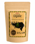 A stand-up kraft paper pouch of Radico Colour Me Organic Ash Blonde hair color, featuring a central label with a black hair silhouette and a brown color circle.