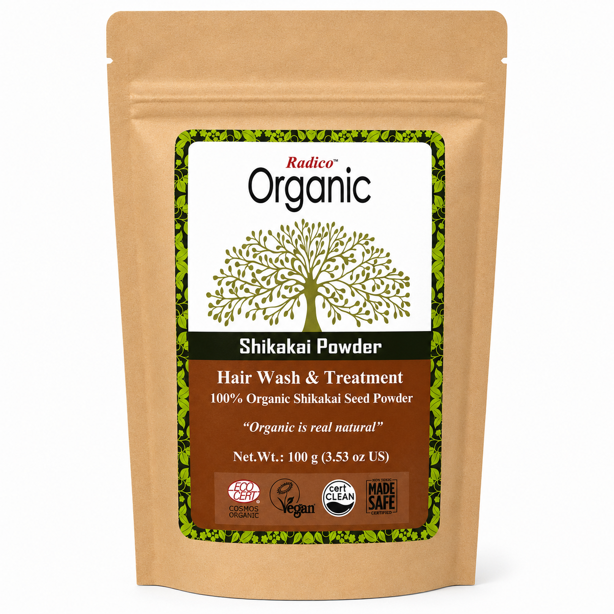 A stand-up kraft paper pouch of Radico Organic Shikakai Powder hair wash and treatment, featuring a white and brown label with a green tree graphic and certification logos.