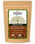 A stand-up kraft paper pouch of Radico Organic Shikakai Powder hair wash and treatment, featuring a white and brown label with a green tree graphic and certification logos.